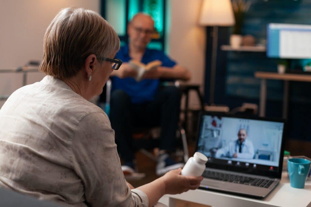 Caucasian old woman using online conference video call
