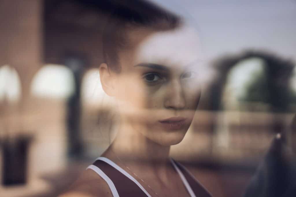 Young sad Woman Looking through the window